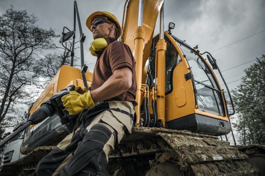 Proud Contractor In Front of Excavator